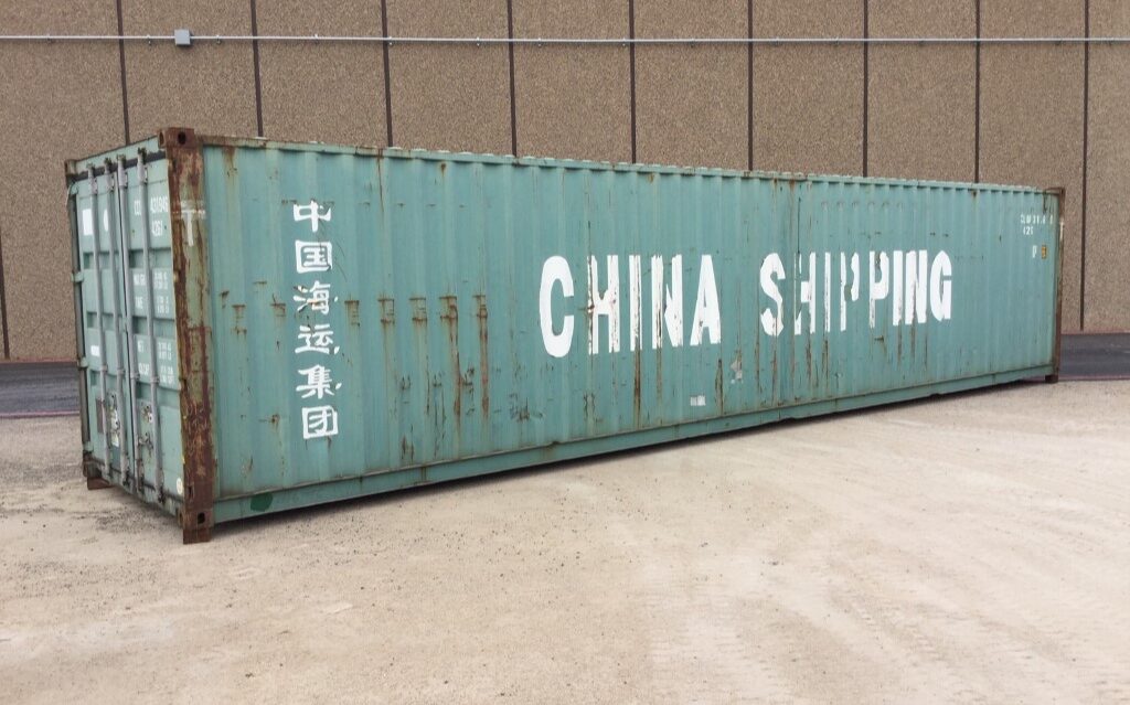 Green shipping container labeled "China Shipping.
