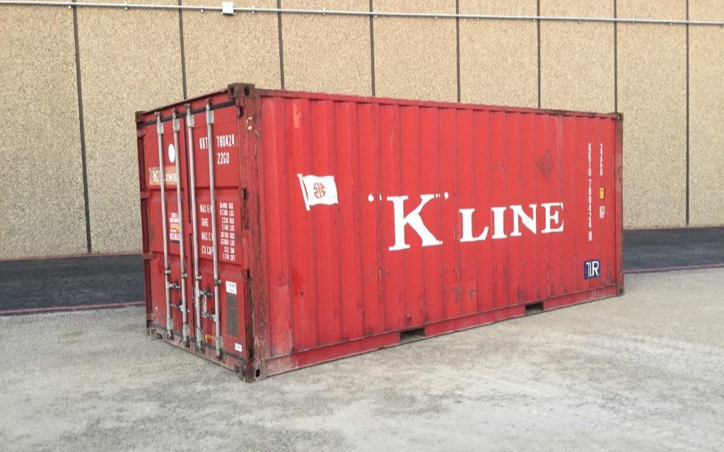 Red shipping container labeled "K Line" outside.