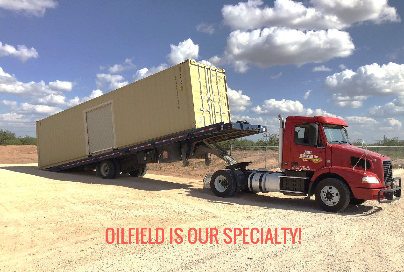 Truck unloading large container in oilfield.